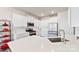 This bright kitchen offers white cabinets, stainless steel appliances and quartz countertops at 14030 Turncloak Dr, Charlotte, NC 28278