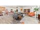 Open-concept living room with fireplace, large TV, stylish furnishings, and natural light at 14030 Turncloak Dr, Charlotte, NC 28278