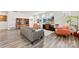 Open-concept living room with fireplace, large TV, stylish furnishings, and natural light at 14030 Turncloak Dr, Charlotte, NC 28278