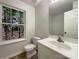 Well-lit bathroom with a single sink vanity and a large window at 1411 Swaying Branch Ln, Clover, SC 29710