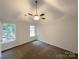 Simple bedroom with neutral carpet, large windows, and a ceiling fan at 1411 Swaying Branch Ln, Clover, SC 29710
