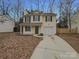 Charming two-story home with a well-maintained lawn and attached garage at 1411 Swaying Branch Ln, Clover, SC 29710