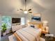 Bright bedroom featuring a large window, ceiling fan, and modern decor at 1411 Swaying Branch Ln, Clover, SC 29710