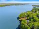 Aerial view of lakefront home on peninsula at 16 Sunrise Point Ct with private dock and lush surroundings at 16 Sunrise Point Ct, Lake Wylie, SC 29710