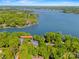 Aerial view of lakefront property at 16 Sunrise Point Ct nestled among trees with private dock at 16 Sunrise Point Ct, Lake Wylie, SC 29710