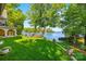Backyard featuring lush lawn, landscaped garden, and serene waterfront views at 16 Sunrise Point Ct, Lake Wylie, SC 29710