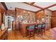 Interior bar with wooden bar, hardwood floors, wooden ceiling and three chairs at 16 Sunrise Point Ct, Lake Wylie, SC 29710