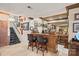 Basement bar area featuring a countertop, two bar stools, glassware and decoratively adorned walls at 16 Sunrise Point Ct, Lake Wylie, SC 29710