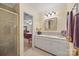 Well-lit bathroom showcasing a vanity with white cabinetry and a shower with a glass door at 16 Sunrise Point Ct, Lake Wylie, SC 29710