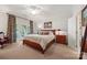 Bedroom with a large bed, side table, and sliding glass doors that offer plenty of natural light at 16 Sunrise Point Ct, Lake Wylie, SC 29710