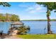 Beautiful dock with gazebo offers serene waterfront views on a sunny day at 16 Sunrise Point Ct, Lake Wylie, SC 29710