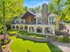 Stunning lakefront home featuring an stone chimney, second story balcony and a landscaped front lawn at 16 Sunrise Point Ct, Lake Wylie, SC 29710