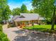 Beautiful lakefront home with lush landscaping, mature trees and charming exterior details at 16 Sunrise Point Ct, Lake Wylie, SC 29710
