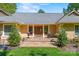Inviting front entrance with detailed wood double doors, manicured lawn, and elegant landscaping at 16 Sunrise Point Ct, Lake Wylie, SC 29710