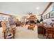 Spacious living room with leather furniture, a stone fireplace, decorative lighting, and ample seating at 16 Sunrise Point Ct, Lake Wylie, SC 29710