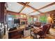 Living room with beamed ceilings, fireplace, and a view to the outside at 16 Sunrise Point Ct, Lake Wylie, SC 29710