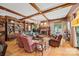 Living room with beamed ceilings, fireplace and bookshelves with a view of the outdoors at 16 Sunrise Point Ct, Lake Wylie, SC 29710