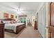 Spacious main bedroom featuring a large bed, ceiling fan, and a sliding glass door leading to the outside at 16 Sunrise Point Ct, Lake Wylie, SC 29710