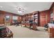 Large office with wood paneling, built-in bookshelves, and a ceiling fan at 16 Sunrise Point Ct, Lake Wylie, SC 29710