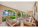 Spacious, covered patio offering comfortable seating and picturesque views of the backyard and lake at 16 Sunrise Point Ct, Lake Wylie, SC 29710