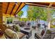 Spacious outdoor patio with wood ceiling, stone fireplace, and lake views offers ideal space for relaxation at 16 Sunrise Point Ct, Lake Wylie, SC 29710