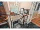 Elegant staircase with white railings, black marble floors, chandelier, and window with natural light at 16 Sunrise Point Ct, Lake Wylie, SC 29710