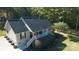 Beautifully landscaped home with manicured lawn, a covered front porch, and mature trees offering privacy at 1661 California Rd, York, SC 29745