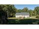 Expansive backyard featuring a deck, lush lawn, and surrounded by mature trees at 1661 California Rd, York, SC 29745