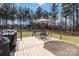 A spacious deck with an outdoor dining set is ready for relaxing and entertaining at 1661 California Rd, York, SC 29745