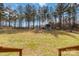 A spacious, tree-lined backyard has a playhouse and room to roam at 1661 California Rd, York, SC 29745