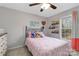 Cozy bedroom with natural light from the window and a ceiling fan at 1661 California Rd, York, SC 29745