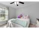 Cozy bedroom with natural light from the window and a ceiling fan at 1661 California Rd, York, SC 29745