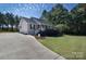 Charming single-story home featuring a well-manicured lawn, beautiful landscaping, and a welcoming front porch at 1661 California Rd, York, SC 29745