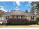 Inviting single-story home featuring manicured landscaping, a covered front porch, and classic architectural details at 1661 California Rd, York, SC 29745
