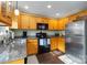 A kitchen featuring wooden cabinets, granite countertops and stainless steel refrigerator at 1661 California Rd, York, SC 29745