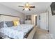 Comfortable bedroom featuring neutral walls, a ceiling fan, and an adjacent bathroom and closet at 1661 California Rd, York, SC 29745