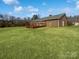 Spacious, level backyard with a large wooden deck and mature trees offers great privacy at 189 Beech Brook Ln, Statesville, NC 28625
