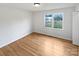 Bright bedroom featuring hardwood floors, a window with a view, and freshly painted white walls at 189 Beech Brook Ln, Statesville, NC 28625