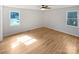 Well-lit bedroom featuring hardwood floors and a bright window with views of the outdoors at 189 Beech Brook Ln, Statesville, NC 28625