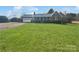 Charming brick home with attached garage, manicured hedges, and a lush green front yard at 189 Beech Brook Ln, Statesville, NC 28625