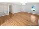 Bright living room featuring hardwood floors, natural light, and a built-in bookshelf at 189 Beech Brook Ln, Statesville, NC 28625
