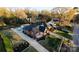 Aerial view showcasing the home's well-maintained landscaping, driveway, brick exterior, and the surrounding neighborhood at 1937 Wilmore Dr, Charlotte, NC 28203