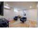 Basement living area with a TV, armchairs, wood-style flooring, and a walkout door at 1937 Wilmore Dr, Charlotte, NC 28203