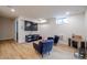 Cozy basement living area with a TV, armchairs, and wood-style flooring at 1937 Wilmore Dr, Charlotte, NC 28203