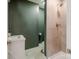 Stylish bathroom featuring a walk-in shower, neutral tiles, and olive green accent wall at 1937 Wilmore Dr, Charlotte, NC 28203