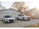 Spacious driveway leading to a two car garage and a charming red brick home with well-maintained landscaping at 1937 Wilmore Dr, Charlotte, NC 28203