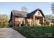A quaint brick home with a well-manicured lawn and a welcoming front porch at 1937 Wilmore Dr, Charlotte, NC 28203
