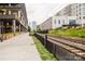 View from outdoor pedestrian walkway featuring landscaping, train tracks and modern building architecture at 1937 Wilmore Dr, Charlotte, NC 28203