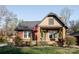Charming brick home featuring an American flag, landscaped yard, and inviting front porch at 1937 Wilmore Dr, Charlotte, NC 28203