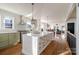 Open concept kitchen with stainless steel appliances, eat in island and access to living areas at 1937 Wilmore Dr, Charlotte, NC 28203